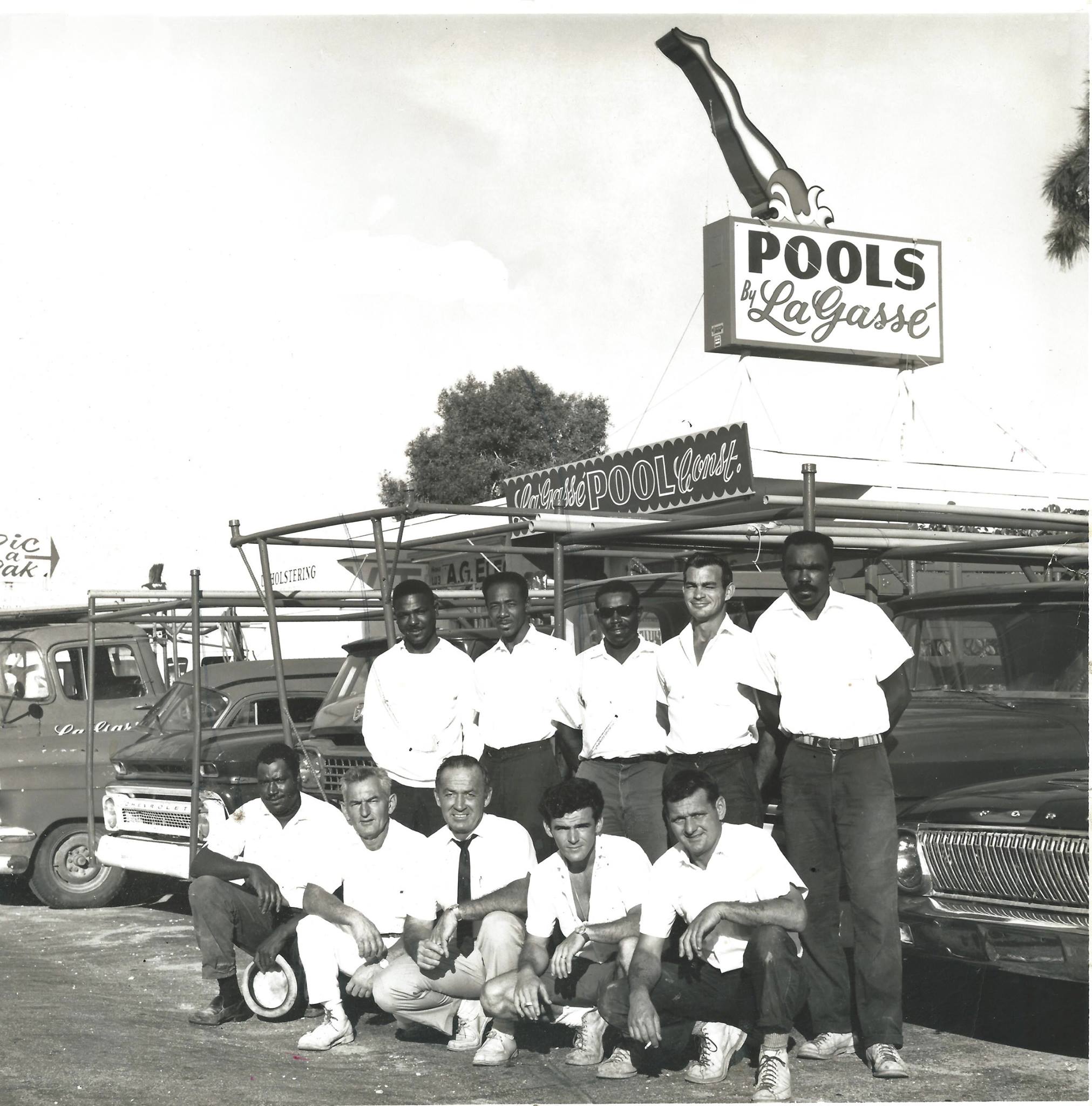 468368933_10160413080560318_865861867358529492_n Photo of original staff in front of the Lagasse Pools building and sign black and white